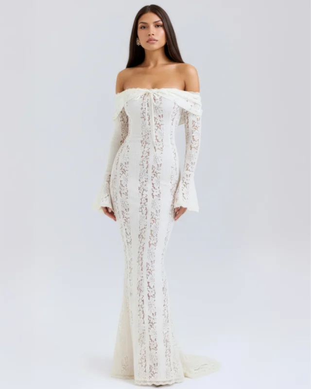 Front full-length shot of the Amandine off-the-shoulder maxi gown in romantic white lace, featuring an elegant tie-front neckline, dramatic long bell sleeves, and a sweeping mermaid column train.