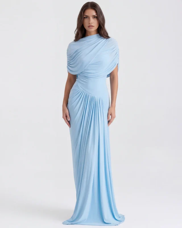 Front full-length view of The Camille Asymmetrical Draped Shawl Maxi Gown in baby blue, showcasing the elegant crew neckline, integrated upper-body wrap shawl, and dramatic column-pleated skirt.