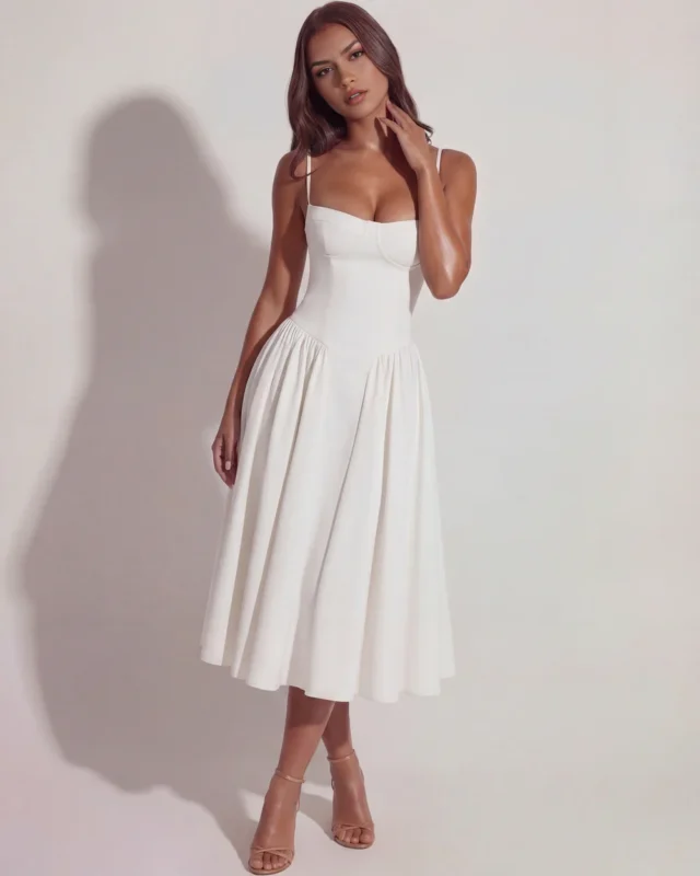 Front full-length view of The Delphine Bustier Midi Dress in elegant white, highlighting the structured underwired corset bodice, supportive cupped design, and high-volume gathered midi skirt.