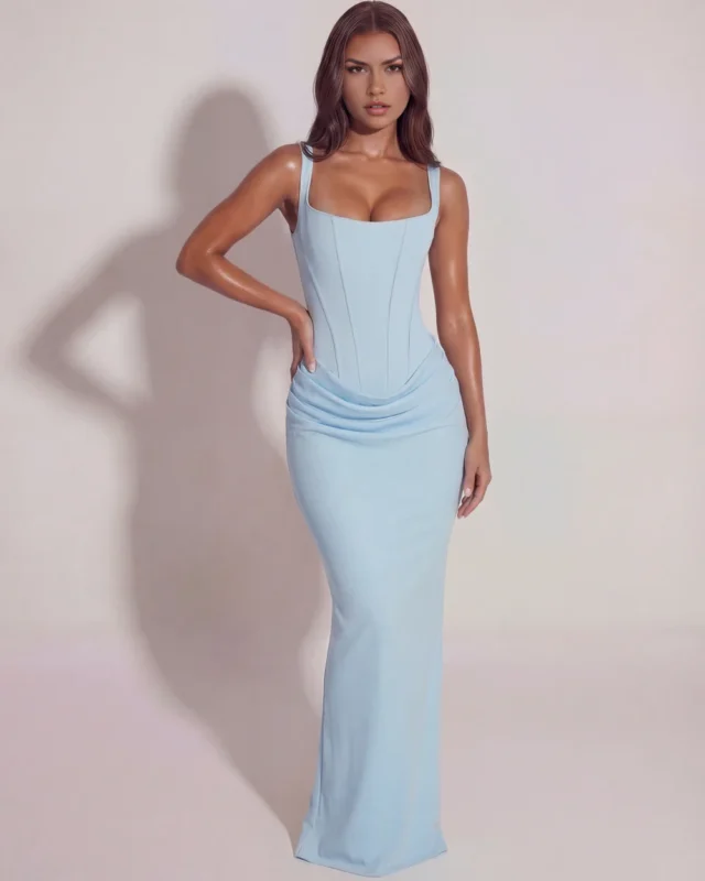 Front full-length portrait of a premium light blue corset gown, emphasizing the supportive wide shoulder straps, dramatic hip-cinching definition, and an elegant formal event aesthetic.