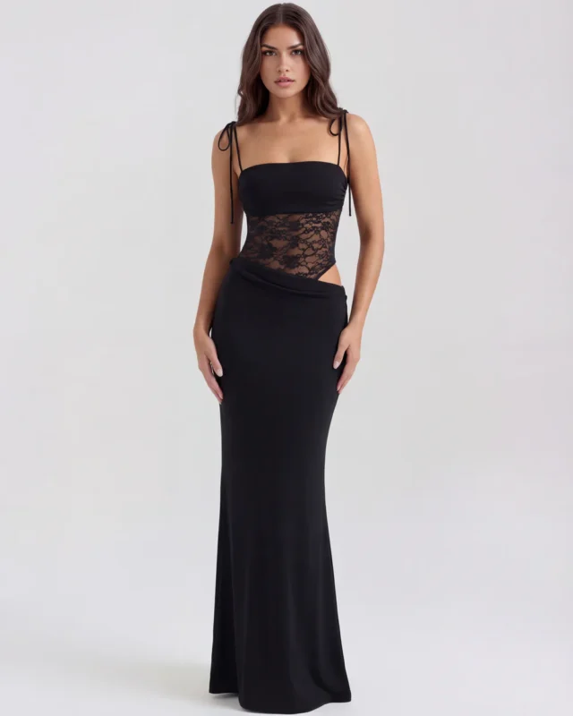 Front full-length portrait of the Francesca black maxi gown, showcasing a straight strapless-style neckline with thin shoulder tie straps, a sheer floral lace corset midsection insert, and a sleek column skirt with a asymmetric hip overlay.
