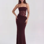 Front full-length studio shot of the Francesca burgundy maxi gown, featuring a rich wine-colored body, sheer lace corset waist, side hip cutout, and a sophisticated draped long skirt.