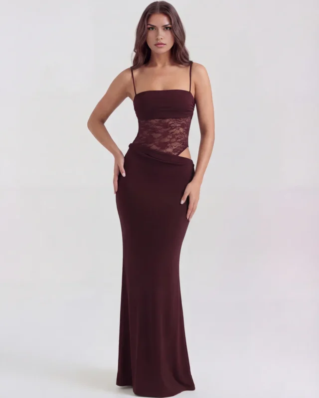 Front full-length studio shot of the Francesca burgundy maxi gown, featuring a rich wine-colored body, sheer lace corset waist, side hip cutout, and a sophisticated draped long skirt.