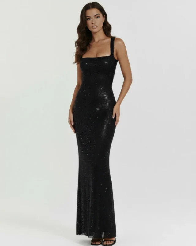 Front full-length studio portrait of the Genevieve black maxi gown, showcasing a tailored square neckline, thick supportive shoulder straps, and a body-contouring column silhouette entirely encrusted with shimmering crystals.