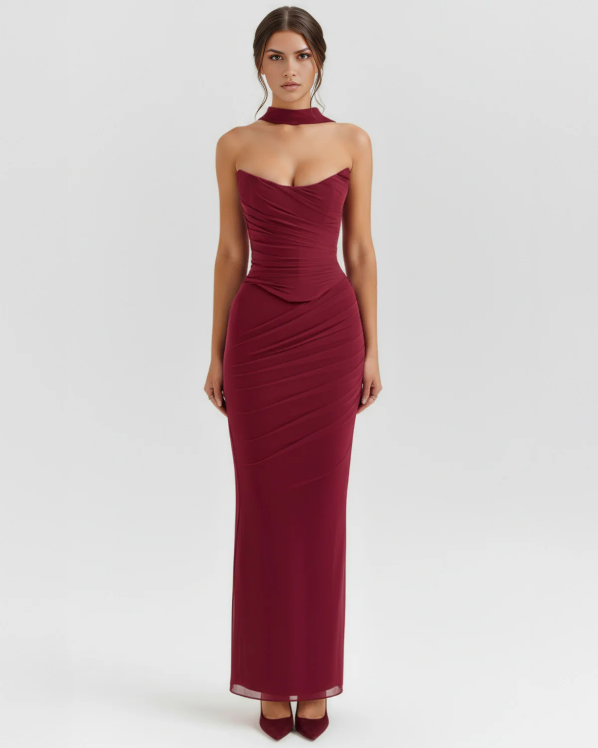 The Mariana Corset & Ruched Burgundy Maxi Skirt Mesh Three-Piece Set 01 Front full-length portrait of the Victoria burgundy maxi gown, showcasing a strapless curved sweetheart neckline with fine ruching across the corseted mesh bodice, a matching wine-colored fabric neck choker, and a sleek column-style skirt.