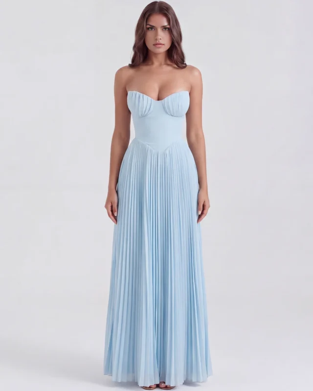 Front full-length portrait of the Nerida strapless maxi gown in baby blue, showcasing the unique gathered pleating on the sweetheart bustier cups, a smooth contoured waist, and a floor-sweeping accordion pleated skirt.