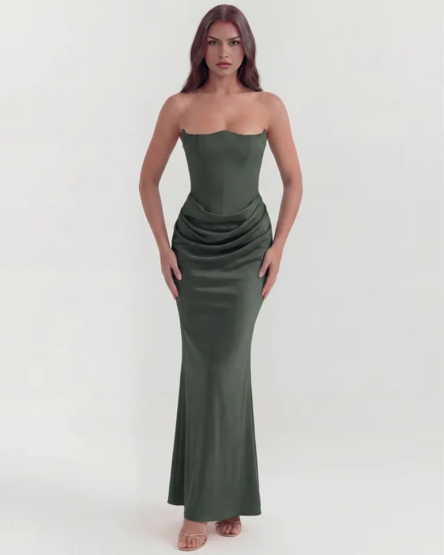 Front full-length shot of the Rosalinda strapless corset maxi gown in deep forest green, emphasizing the architectural pointed neckline and body-sculpting drop-waist satin draping.