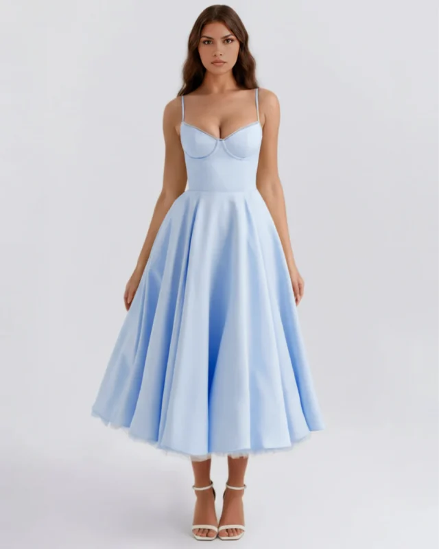 Front full-length shot of a romantic powder blue midi dress featuring a structured sweetheart corset bodice with delicate contrast cup trim, thin spaghetti straps, and a voluminous flared A-line skirt with a peeking tulle petticoat.